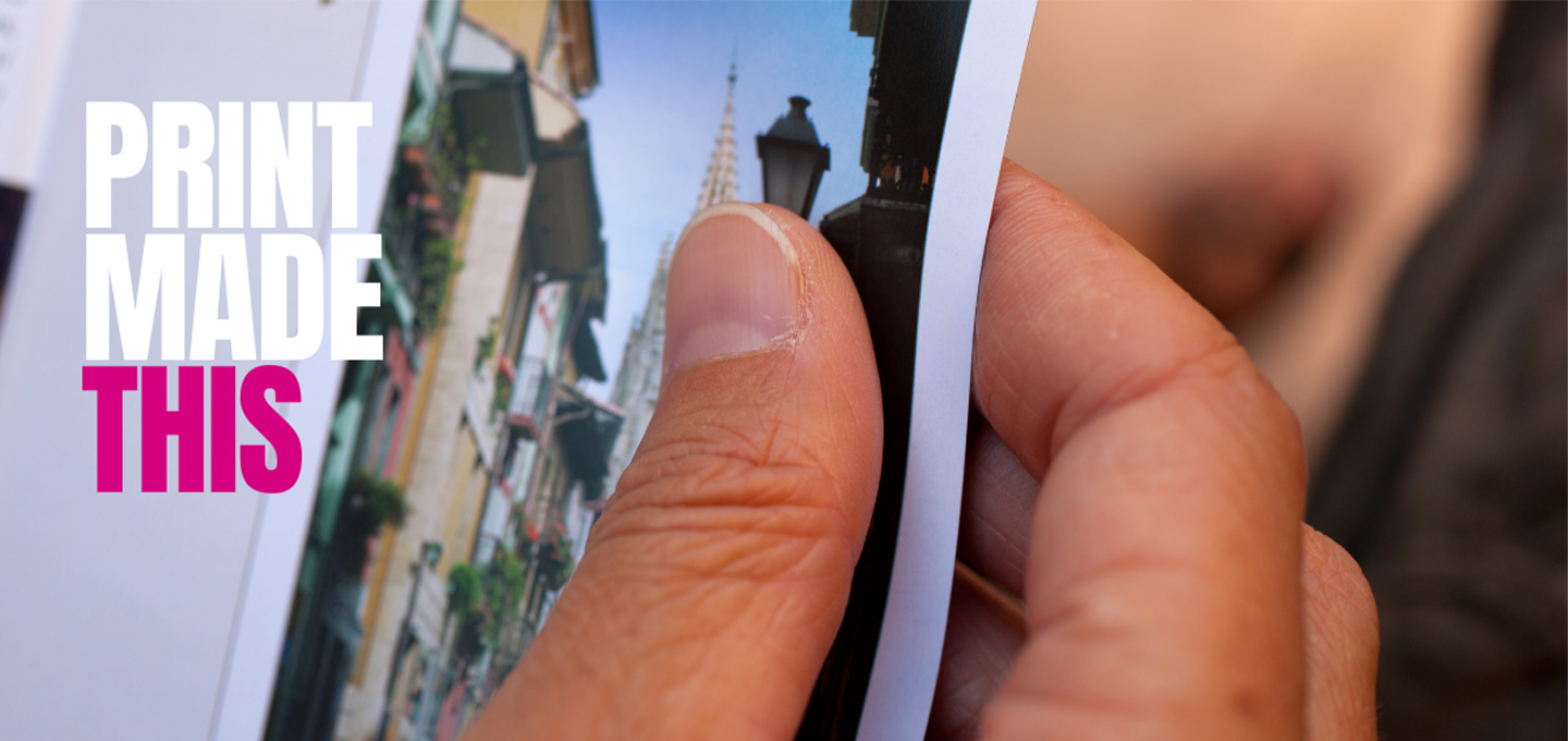 A hand is holding a printed photo of an old street. The words 'Print Made This' are overlaid on the image.