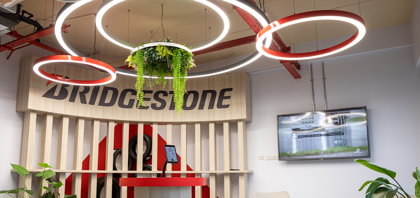 Bridgestone branded experience area showcasing innovation, digital displays and a modern corporate environment within a professional workspace.
