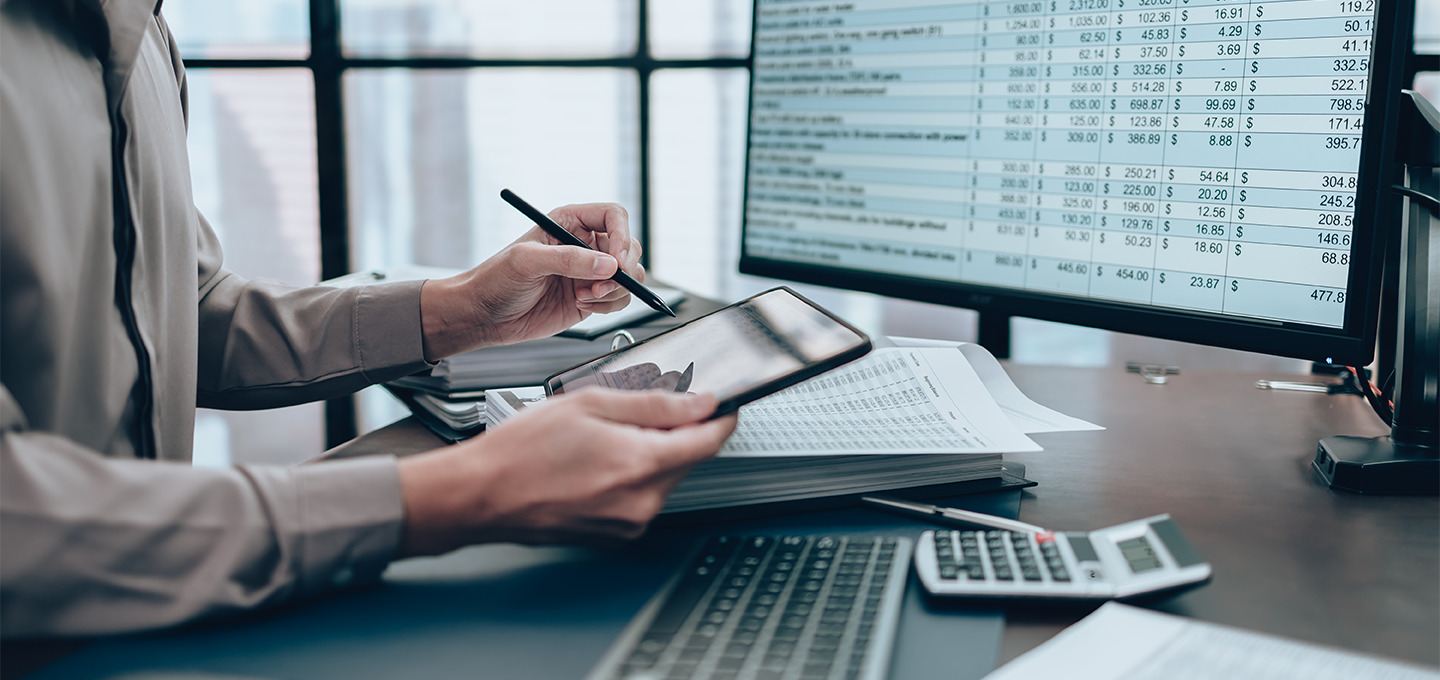 accounts payable professional working at a laptop with a calculator