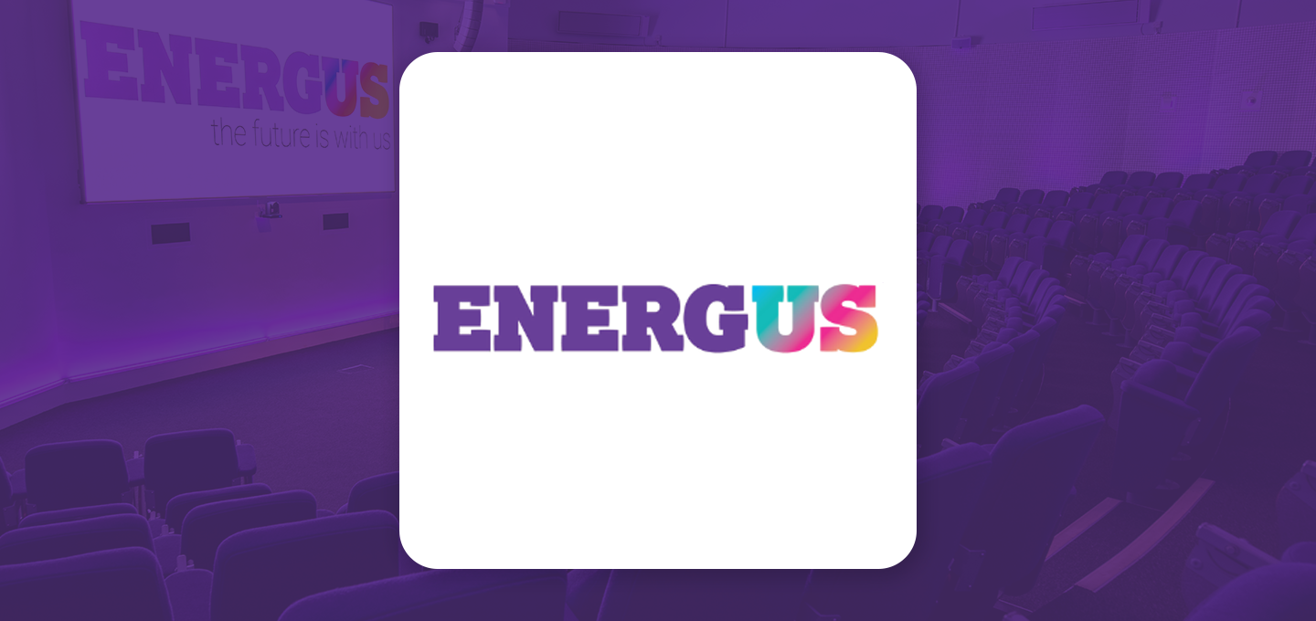 Energus logo displayed over a conference auditorium background, representing professional event management, business conferences, training sessions, and corporate events.