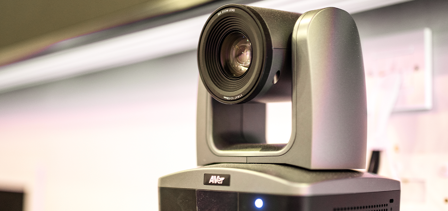 Professional PTZ video conferencing camera mounted in a modern meeting room, enabling high-quality video collaboration, hybrid meetings, remote communication, and business presentations.