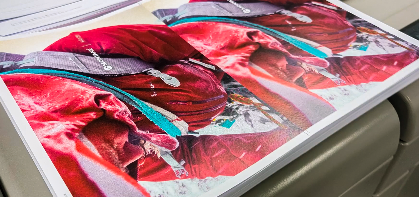 High‑quality printed pages featuring a vivid outdoor scene in bold red tones, shown stacked on a printer tray. Ideal visual for showcasing professional printing, colour accuracy, and premium print production.