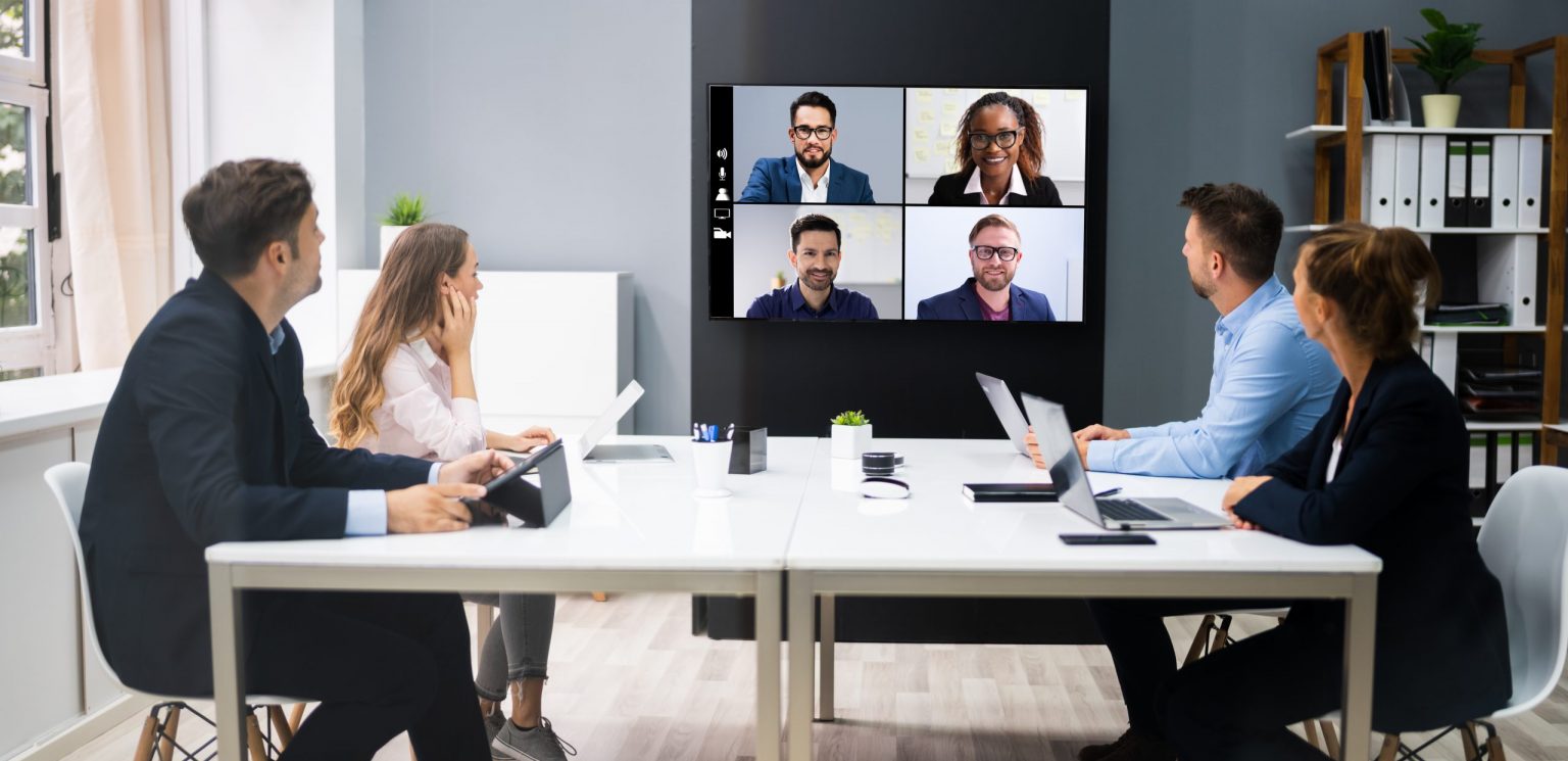 People sitting in conference room having online meeting
