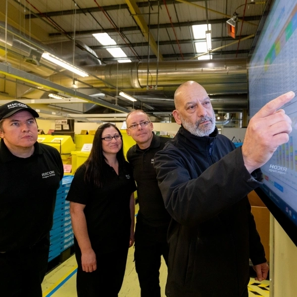 Ricoh employees analysing performance in the gemba.